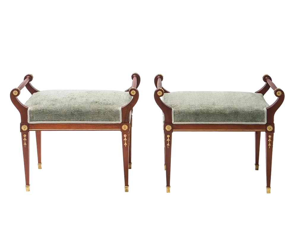 Two classical-style benches with green cushions on a white background