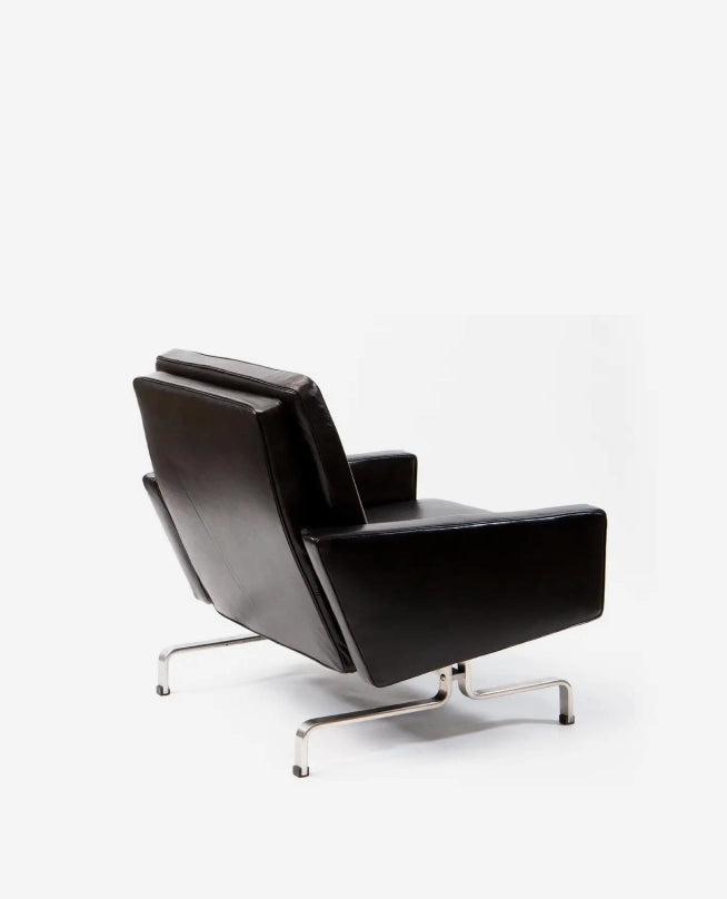 Black leather armchair with chrome legs on a white background
