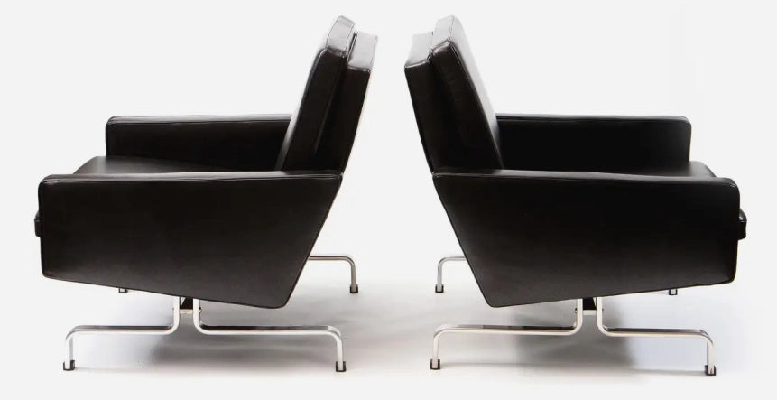 Two black armchairs on a white background