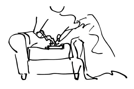 Simplified line drawing of a person sitting on a couch.